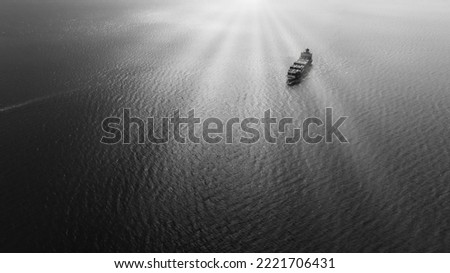 black and white cargo container ship full speed sailing in sea import and export business and industry logistic goods transportation of international by container ship in ocean fright and sunlight