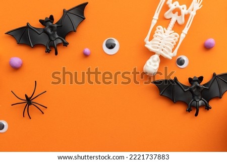 Halloween background with skeletons, bats eyes and spiders