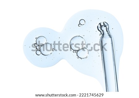 Pipette and drops of cosmetic serum for the skin. Liquid body care product. Isolated on a white background. Royalty-Free Stock Photo #2221745629