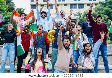 excited audience celebrating sixer by shouting and screaming by showing hand gestures and signs while watching cricket match at stadium - concept of entertainment, enjoyment and joyful spectators