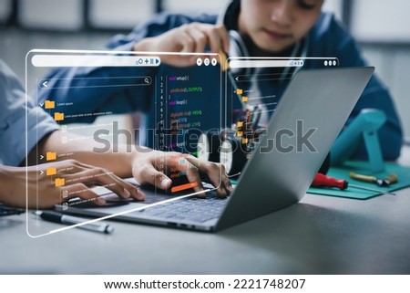 Asian teenager students doing robot arm and robotic cars homework project in house using computers and coding. technology of robotics programing and STEM education concept. Royalty-Free Stock Photo #2221748207