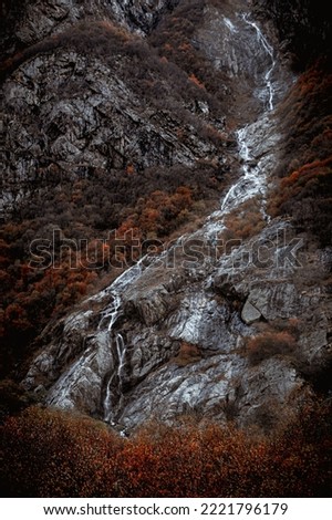 high mountain waterfall in autumn
