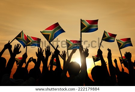 Group of People Waving South African Flags in Back Lit Royalty-Free Stock Photo #222179884