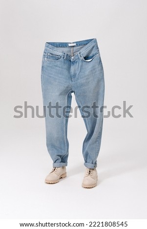 Blue jeans with shoes. Creative idea of photographing clothes. Advertising comfortable jeans