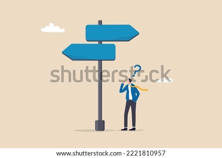 Choosing between 2 choices, make decision to the left or right, thinking in difficult situation, confusion concept, businessman thinking with question mark choose between 2 direction with copy space. Royalty-Free Stock Photo #2221810957