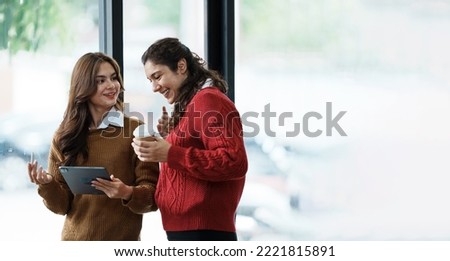 Friends using smartphone and having coffee in a coffee shop Royalty-Free Stock Photo #2221815891