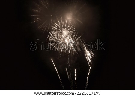 Retro white holiday fireworks background with sparks, colored stars and bright nebula on black night sky. Amazing beauty colorful fireworks display on celebration, showing. Holidays backgrounds