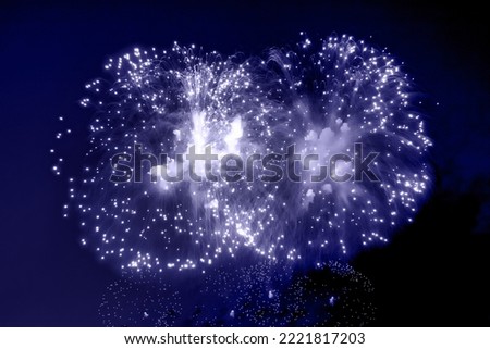 Blue holiday fireworks background with sparks, colored stars and bright nebula on black night sky universe. Amazing beauty colorful fireworks display on celebration, showing. Holidays backgrounds
