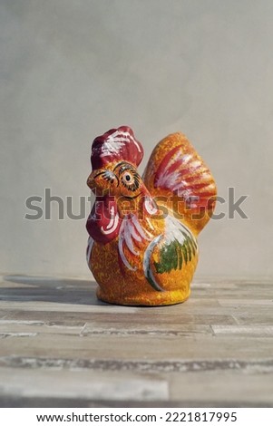 Chicken piggy bank for saving money against the backdrop of concrete walls