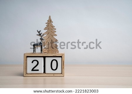 Christmas white wooden calendar number cube with date 20. Decorated with deer and Christmas tree. More dates in my portfolio. Background for text.