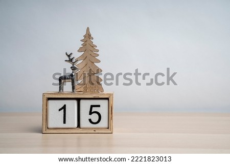 Christmas white wooden calendar number cube with date 15. Decorated with deer and Christmas tree. More dates in my portfolio. Background for text.