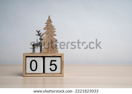 Christmas white wooden calendar number cube with date 05. Decorated with deer and Christmas tree. More dates in my portfolio. Background for text.
