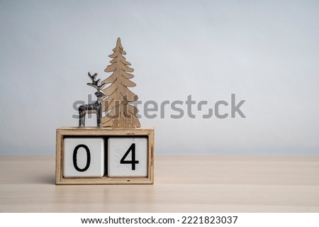 Christmas white wooden calendar number cube with date 04. Decorated with deer and Christmas tree. More dates in my portfolio. Background for text.