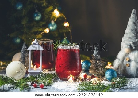Frosted Mistletoe Margarita Frosted Mistletoe Margarita Cocktail in elegant glasses with water drops, festive Christmas or New Year background