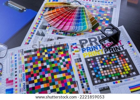 Magnifying glasses for checking print quality of media graphics proof print in printing industry. Selected focus Royalty-Free Stock Photo #2221859053
