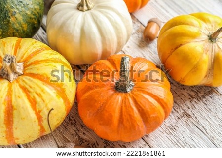 Ripe Halloween pumpkins on light wooden table, closeup