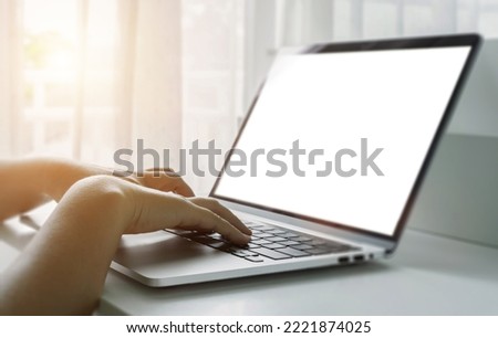 Close up of female hands using laptop at home office. Concept of searching web, browsing information. soft focus