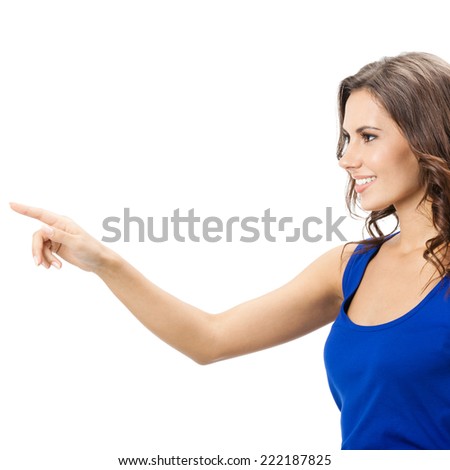 Happy smiling beautiful young woman showing copyspace, visual imaginary or something, or pressing virual button isolated over white background