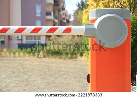 Closed automatic boom barrier on sunny day outdoors, closeup