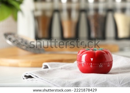 Kitchen timer in shape of tomato on white table. Space for text Royalty-Free Stock Photo #2221878429