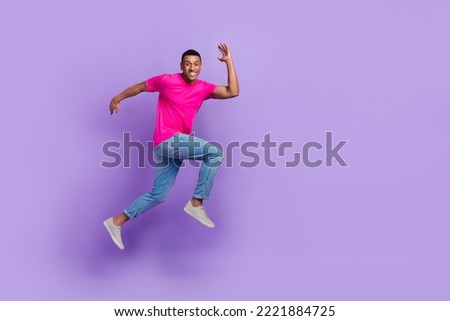 Full length photo of excited energetic person jump run rush empty space isolated on violet color background