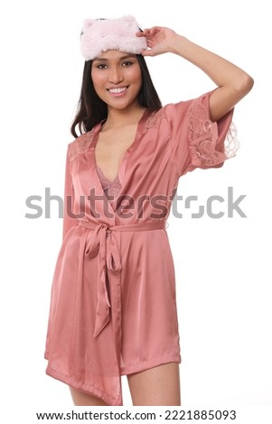Very positive Asian female in nightwear.