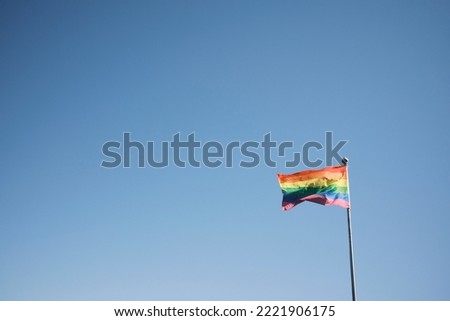 LGBT flag against blue sky Royalty-Free Stock Photo #2221906175