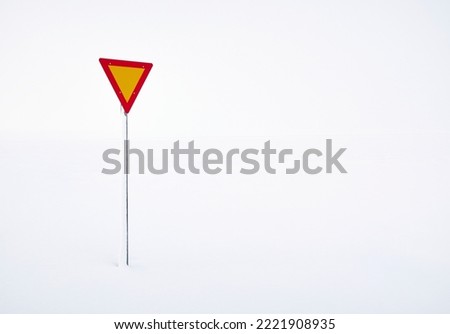 Yield sign located on snowy field