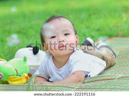 asian baby was playing happily in the park