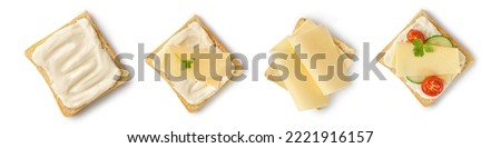 Set of toasts with melted and sliced cheese on bread. Assortment of sandwiches with gouda cheese, tomatoes, cucumber isolated on a white background with clipping path. Top view. Royalty-Free Stock Photo #2221916157