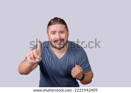 A man desperately asks for one more chance, while pleading his case. Isolated on a gray background. Royalty-Free Stock Photo #2221942409