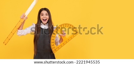 happy kid hold math protractor and ruler in school on yellow background, education. Horizontal isolated poster of school girl student. Banner header portrait of schoolgirl copy space.