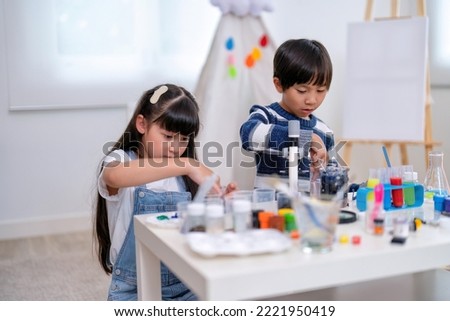 At school children play education study mix paint with water in laboratory glass as scientist