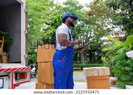 Delivery house move cargo truck service man checking box list from digital tablet for signature