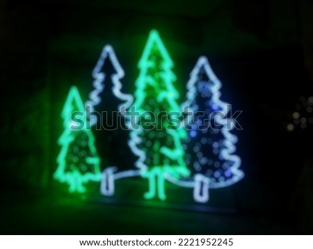 Blurry abstract background of neon christmast tree in the night. defocused photo.