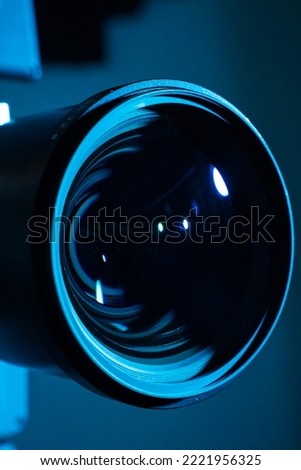 Close-up of a digital camera lens with dark light. Copy space for text vertical.