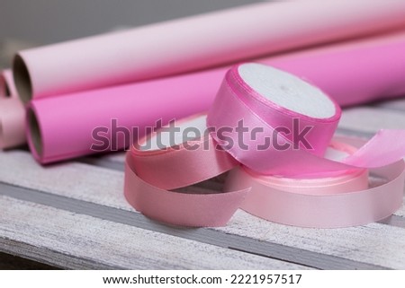 pink paper for wrapping gifts and goods.colored paper for bouquets.wrapping paper and pink ribbon for floristry.gift wrapping paper
