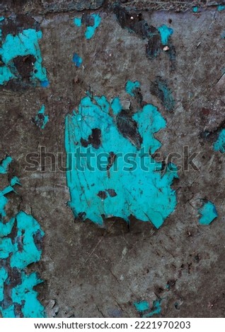 Old blue background. Texture of exfoliating paint from the wall, cracked paint.