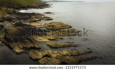 Rocks in seawater, top view. Geological formations on the Atlantic Ocean coast. Drone point of view. Royalty-Free Stock Photo #2221971573