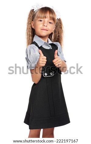Happy little girl. Smiling little girl with backpack showing her thumbs up, isolated on white background.