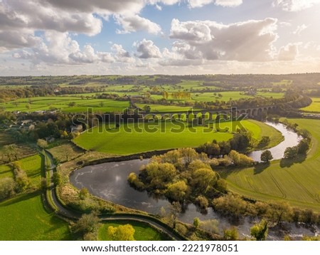 Aerial view over Arthington Viaduct and the River Wharfe on a sunny autumn day. Meandering river bends through the North Yorkshire countryside. UK Royalty-Free Stock Photo #2221978051