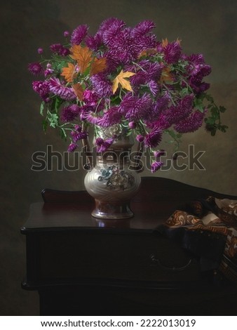 Still life with bouquet of purple chrysanthemums