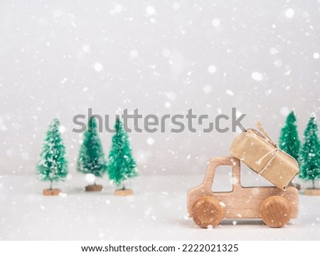 Wooden car carries a gift. Christmas and New Year's Eve Concept