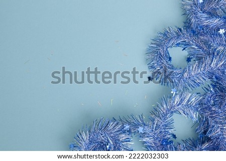 creative festive frame with blue navy streamers on blue pastel background, top view