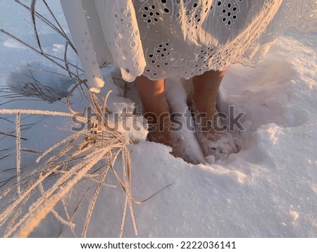 Walking barefoot in the snow. Women's feet. Hardening in the cold. Snowy weather. Cold treatment, low temperature outside.
