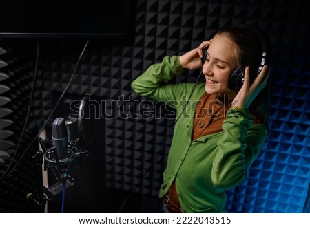 Young teenager girl singer at record studio