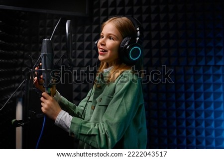 Young teenager girl singer at record studio
