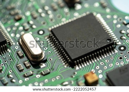 Small microprocessor, microcontroller chip on a generic modern desktop PC computer motherboard, object macro, extreme closeup, shallow dof, nobody Electrical components shortage concept, circuit board Royalty-Free Stock Photo #2222052457