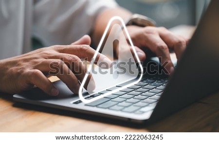 User or developer working on laptop computer with triangle caution warning sign for notification error and maintenance concept, computer virus detected, personal data protection, network security. Royalty-Free Stock Photo #2222063245
