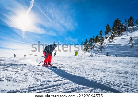 Man skiing down the ski slope or piste in Pyrenees Mountains. Winter ski holidays in El Tarter, Grandvalira, Andorra